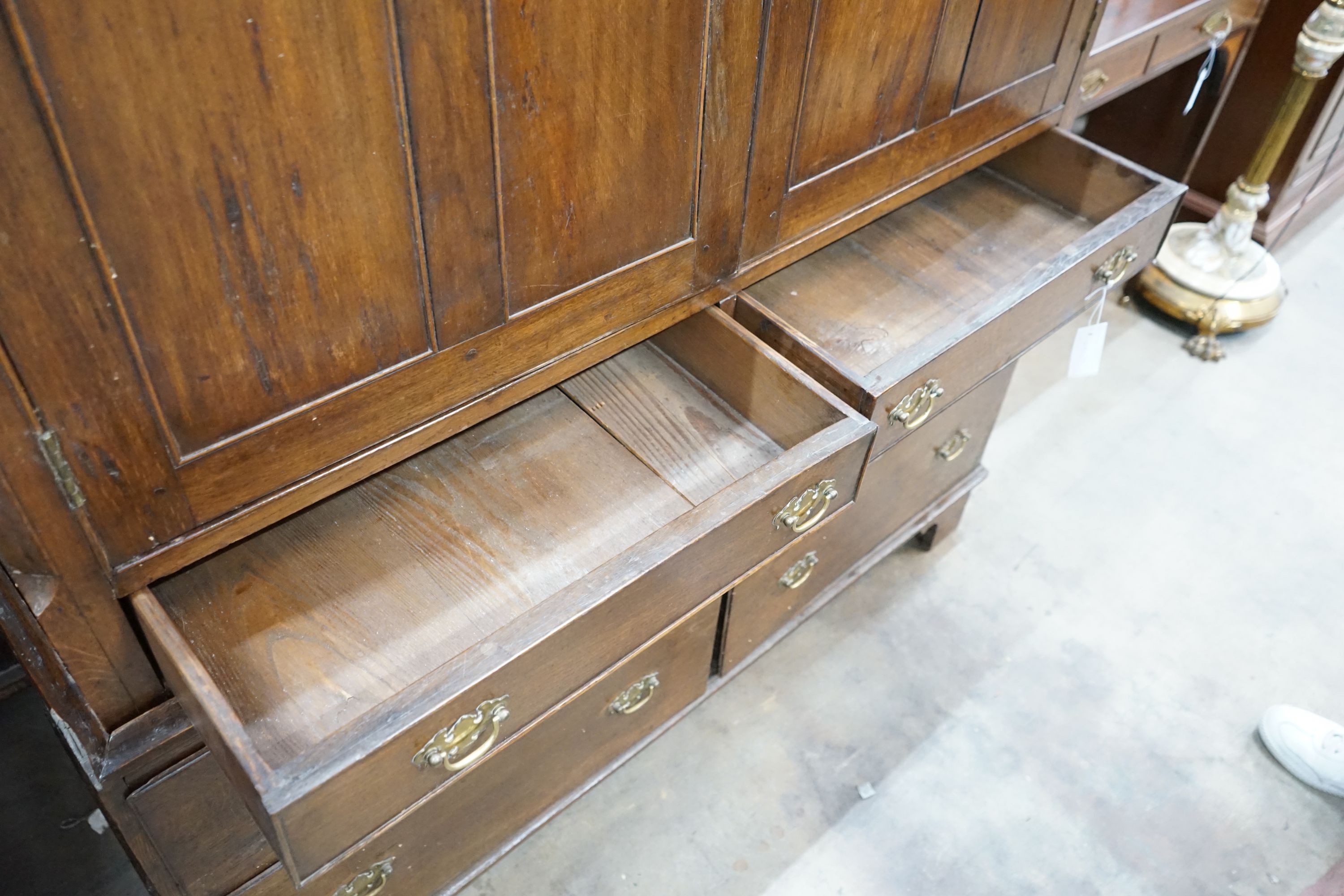 An 18th century oak two section press cupboard, width 127cm, depth 51cm, height 143cm